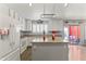 Modern kitchen with white cabinets, an island, stainless steel appliances, and access to backyard at 45722 W Barbara Ln, Maricopa, AZ 85139