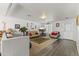 Cozy living room with wood floors, comfortable seating, and bright natural light at 45722 W Barbara Ln, Maricopa, AZ 85139