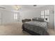 Spacious main bedroom features neutral carpet, ceiling fan, and a cozy sitting area at 45722 W Barbara Ln, Maricopa, AZ 85139