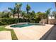 Stunning backyard pool with a waterfall feature, surrounded by lush landscaping and a spacious deck for lounging at 4614 E Reins Rd, Gilbert, AZ 85297