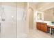 Bright bathroom with a glass shower, large mirror and dual vanities at 4614 E Reins Rd, Gilbert, AZ 85297