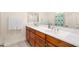 Bathroom featuring double sinks, cherry vanity, white countertops and tile floors at 4614 E Reins Rd, Gilbert, AZ 85297