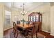 Elegant dining room with decorative hutch, area rug, chandelier, and hardwood floors at 4614 E Reins Rd, Gilbert, AZ 85297