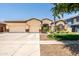 Charming single-story home featuring a spacious three car garage, manicured lawn, and stone accents at 4614 E Reins Rd, Gilbert, AZ 85297