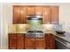Close up view of a kitchen with wood cabinets, granite countertops, and stainless steel JennAir oven at 4614 E Reins Rd, Gilbert, AZ 85297