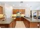 The home offers a gourmet kitchen with double islands and granite countertops at 4614 E Reins Rd, Gilbert, AZ 85297