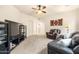 Comfortable living room featuring plush seating, carpet floors, and decorative ceiling fan with built-in lighting at 4614 E Reins Rd, Gilbert, AZ 85297