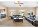 Inviting living room with natural light, fireplace, comfortable seating, and neutral paint palette at 4614 E Reins Rd, Gilbert, AZ 85297