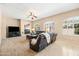 Spacious living room with plenty of natural light, fireplace, ceiling fan, and comfortable seating at 4614 E Reins Rd, Gilbert, AZ 85297