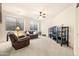 Living room featuring carpeted floors, a ceiling fan, leather furniture and natural lighting at 4614 E Reins Rd, Gilbert, AZ 85297
