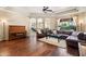 Spacious living room boasts wood floors, ceiling fan and leather furniture at 4614 E Reins Rd, Gilbert, AZ 85297