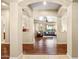 Open-concept living room with hardwood floors, neutral paint, and arched doorways at 4614 E Reins Rd, Gilbert, AZ 85297