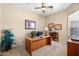 Functional home office with desk, bookshelves, carpet, and natural light at 4614 E Reins Rd, Gilbert, AZ 85297
