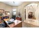 Home office with built-in desk and shelving, bathed in natural light at 4614 E Reins Rd, Gilbert, AZ 85297