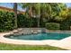 Beautiful pool with rock waterfall feature, surrounded by lush landscaping, is perfect for relaxation and enjoyment at 4614 E Reins Rd, Gilbert, AZ 85297