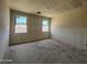 Spacious bedroom with two windows and textured ceiling, ready for your personal touch at 47437 W Kenner Dr, Maricopa, AZ 85139