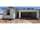 View of new home exterior, showing the garage and entrance during the construction process at 47437 W Kenner Dr, Maricopa, AZ 85139