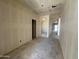 Hallway featuring smooth walls and ceiling, creating a modern aesthetic in a well-lit interior at 47437 W Kenner Dr, Maricopa, AZ 85139