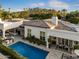 An aerial view shows the home's backyard oasis with manicured landscaping, pool, and shaded dining area at 5700 E Sanna St, Paradise Valley, AZ 85253
