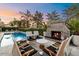 Charming backyard with brick fireplace and pool surrounded by comfortable seating at 5700 E Sanna St, Paradise Valley, AZ 85253