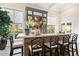 Elegant bar area featuring custom cabinetry, marble countertop, seating, and views of the outdoors at 5700 E Sanna St, Paradise Valley, AZ 85253