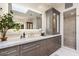 Modern bathroom with marble countertops, custom cabinets, decorative backsplash, and a walk-in shower at 5700 E Sanna St, Paradise Valley, AZ 85253