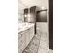 Stylish bathroom boasts black and white patterned tile, a glass shower, and gray walls with decorative accents at 5700 E Sanna St, Paradise Valley, AZ 85253
