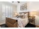 Cozy bedroom featuring a decorative headboard, shuttered windows, and wood-style flooring at 5700 E Sanna St, Paradise Valley, AZ 85253