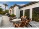 Serene outdoor seating area with stone table and cushioned chairs at 5700 E Sanna St, Paradise Valley, AZ 85253