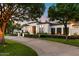 Beautiful home showcasing a well-maintained lawn, manicured landscaping, and black framed windows at 5700 E Sanna St, Paradise Valley, AZ 85253