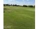 Expansive golf course view showcasing the well-manicured lawn and beautiful sky for a premium golf community at 5700 E Sanna St, Paradise Valley, AZ 85253