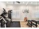 Bright home gym featuring modern workout equipment, mounted TV, mirrored wall, and plantation shutters at 5700 E Sanna St, Paradise Valley, AZ 85253