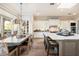 Open-concept kitchen and dining area with island seating and modern lighting at 5700 E Sanna St, Paradise Valley, AZ 85253