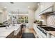 Bright kitchen featuring white cabinets, stainless steel appliances, a large island, and an adjacent eat-in dining area at 5700 E Sanna St, Paradise Valley, AZ 85253