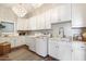 Well-appointed laundry room features ample cabinetry, a utility sink, modern washer and dryer units, and brick flooring at 5700 E Sanna St, Paradise Valley, AZ 85253