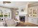 Bright living room features a fireplace, built-in cabinets, and French doors leading to an outdoor space at 5700 E Sanna St, Paradise Valley, AZ 85253