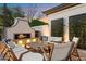 Outdoor patio with a stone fireplace and comfortable seating at 5700 E Sanna St, Paradise Valley, AZ 85253