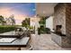 Spacious outdoor kitchen with a built-in grill, bar seating, and a cozy fireplace at 5700 E Sanna St, Paradise Valley, AZ 85253