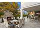 Elegant outdoor living area featuring a brick fireplace, stylish seating, and a covered patio for year-round enjoyment at 5700 E Sanna St, Paradise Valley, AZ 85253