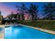 Inviting backyard pool featuring lounge chairs, manicured hedges and an amazing dusk sky at 5700 E Sanna St, Paradise Valley, AZ 85253