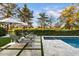 Inviting pool area with lounge chairs, umbrellas, and lush landscaping offering a serene outdoor experience at 5700 E Sanna St, Paradise Valley, AZ 85253