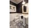 Stylish powder room with intricate tile floors, elegant mirror, and charming nautical wall decor at 5700 E Sanna St, Paradise Valley, AZ 85253