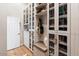 Spacious walk-in closet with custom shelving and a comfortable bench at 5700 E Sanna St, Paradise Valley, AZ 85253
