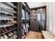 Walk-in closet featuring custom dark wood shelves and a bench seat at 5700 E Sanna St, Paradise Valley, AZ 85253