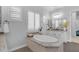 Beautiful bathroom featuring an oval soaking tub, granite counters, double vanity, and shuttered window at 5941 S Cambridge St, Chandler, AZ 85249