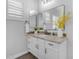 Bright bathroom featuring granite countertops, double mirrors, modern fixtures, and a view of plantation shutters at 5941 S Cambridge St, Chandler, AZ 85249