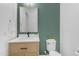 Stylish powder room with a modern vanity, matte black faucet, and accent wall at 5941 S Cambridge St, Chandler, AZ 85249