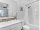 Bright bathroom features a white vanity with mosaic backsplash and a shower-tub combination at 5941 S Cambridge St, Chandler, AZ 85249