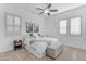 Comfortable bedroom featuring a ceiling fan, neutral carpet, and plantation shutters at 5941 S Cambridge St, Chandler, AZ 85249