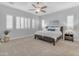 Serene bedroom showcasing neutral tones, a ceiling fan, plantation shutters, and comfortable furnishings at 5941 S Cambridge St, Chandler, AZ 85249